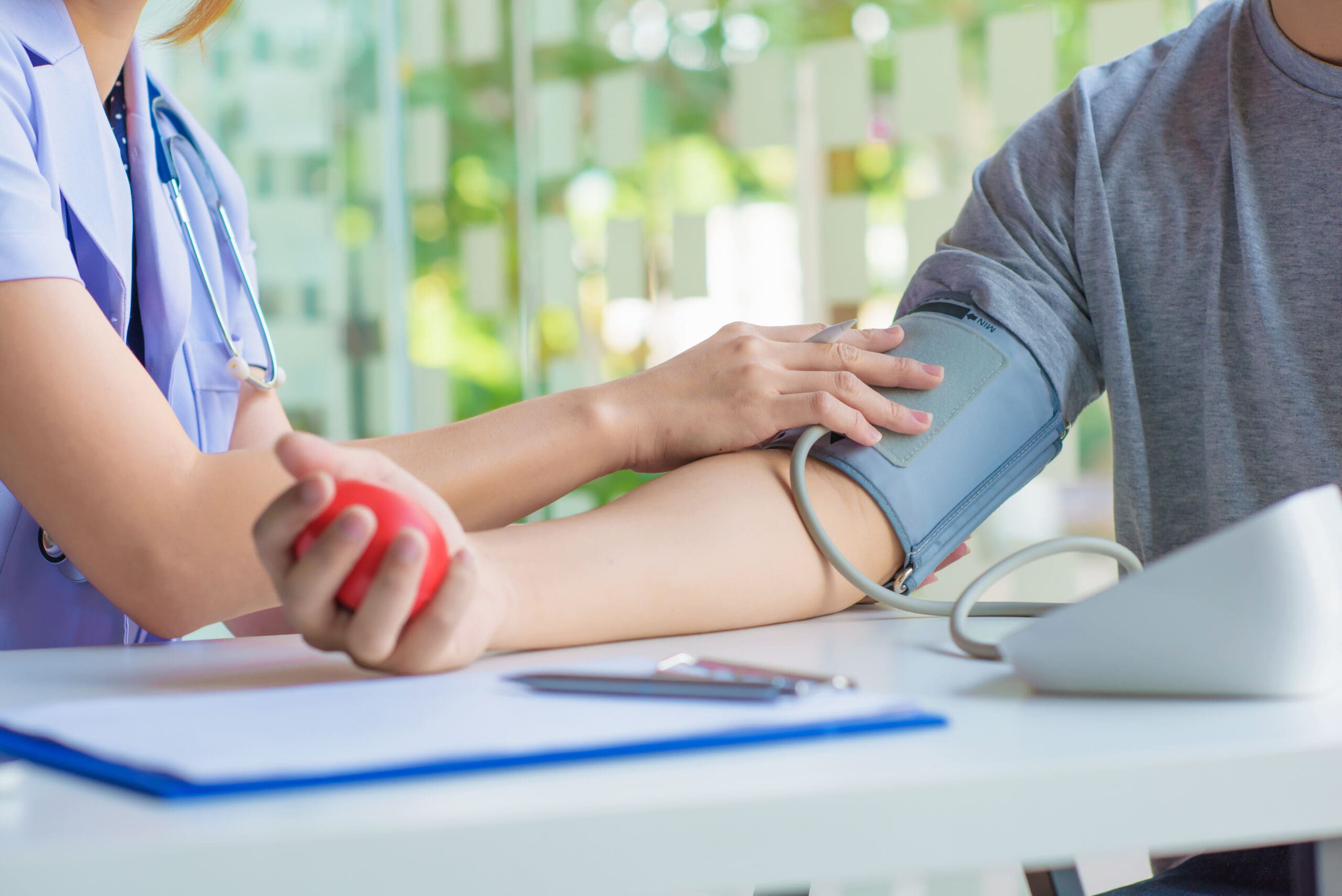 doctor woman checking blood pressure of male patient and heart rate with digital pressure gauge ,Cardiology in medicine and health care concept