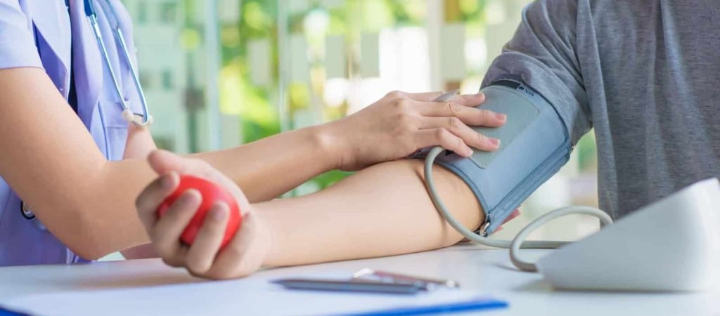 doctor woman checking blood pressure of male patient and heart rate with digital pressure gauge ,Cardiology in medicine and health care concept